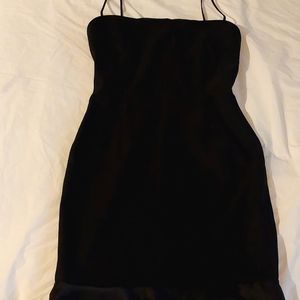 Mini cocktail dress in the color black and small ruffles at the bottom